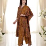 Woman in a mustard floral ethnic suit with dupatta.